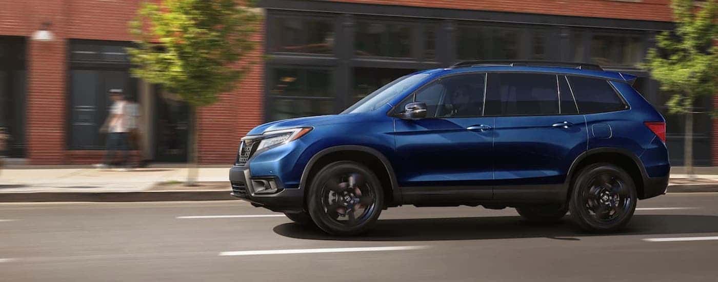 A blue 2021 Honda Passport from the side after leaving a Honda service center near Covington from the side.