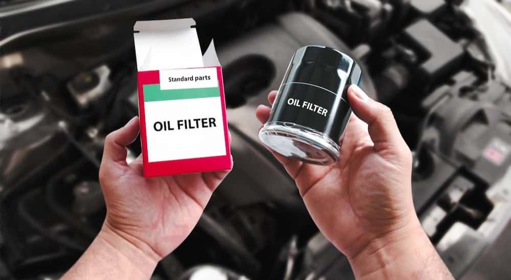 A technician holding an oil filter at a Toyota service center near Covington.