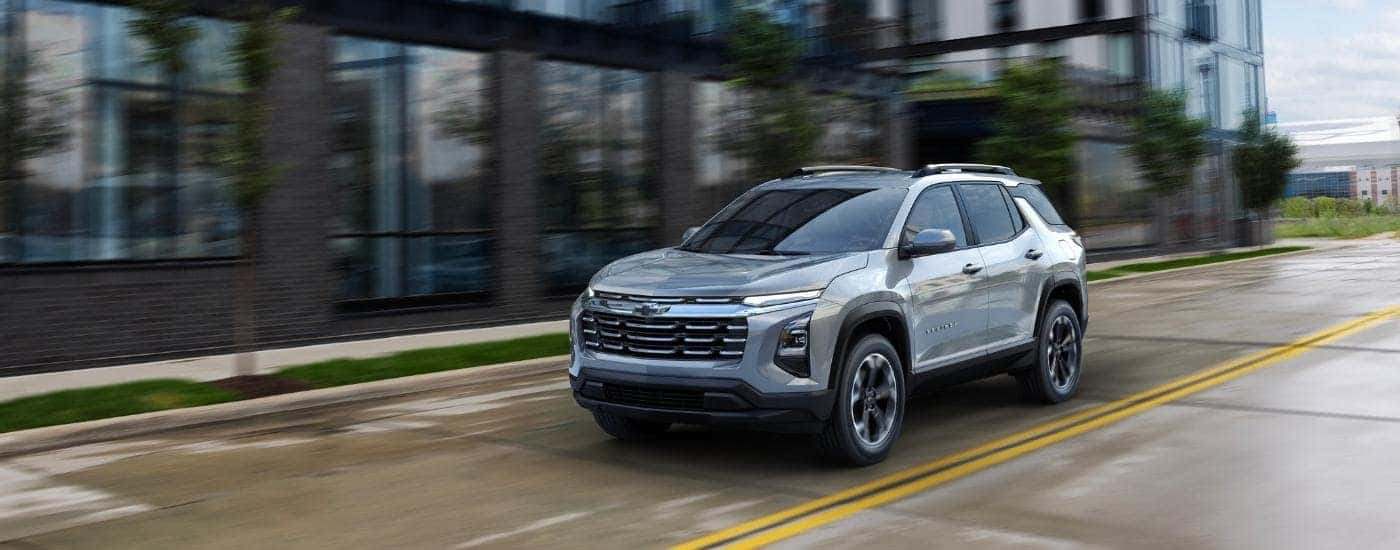 Grey 2025 Chevy Equinox driving on a city street