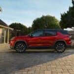 Side of a red 2025 Chevy Equinox RS parked in a driveway