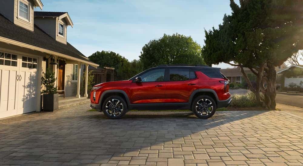 Side of a red 2025 Chevy Equinox RS parked in a driveway