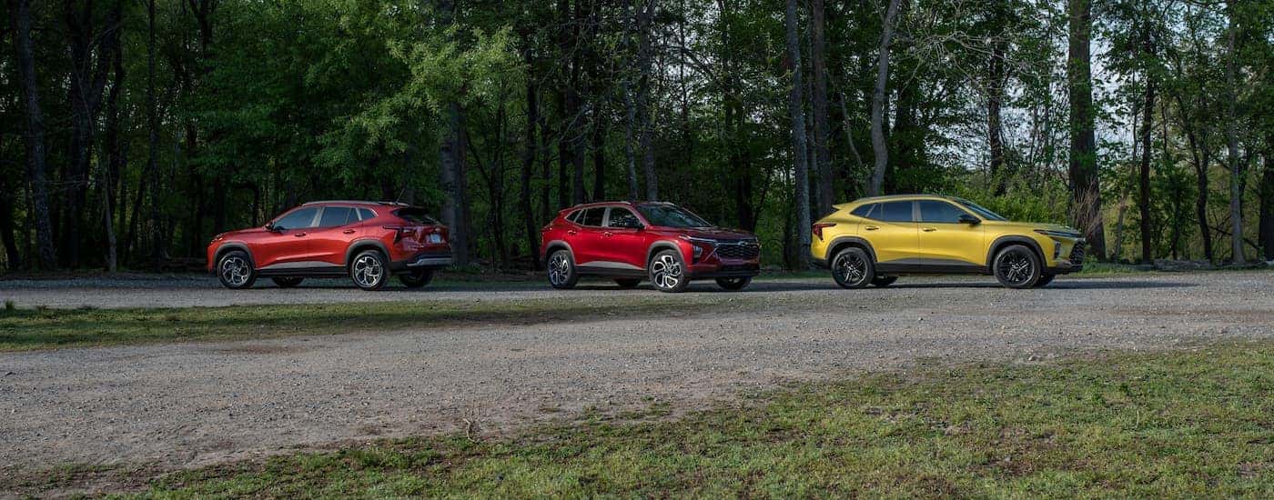Three 2025 Chevy Trax parked on gravel