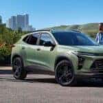 Green 2025 Chevy Trax parked near grass