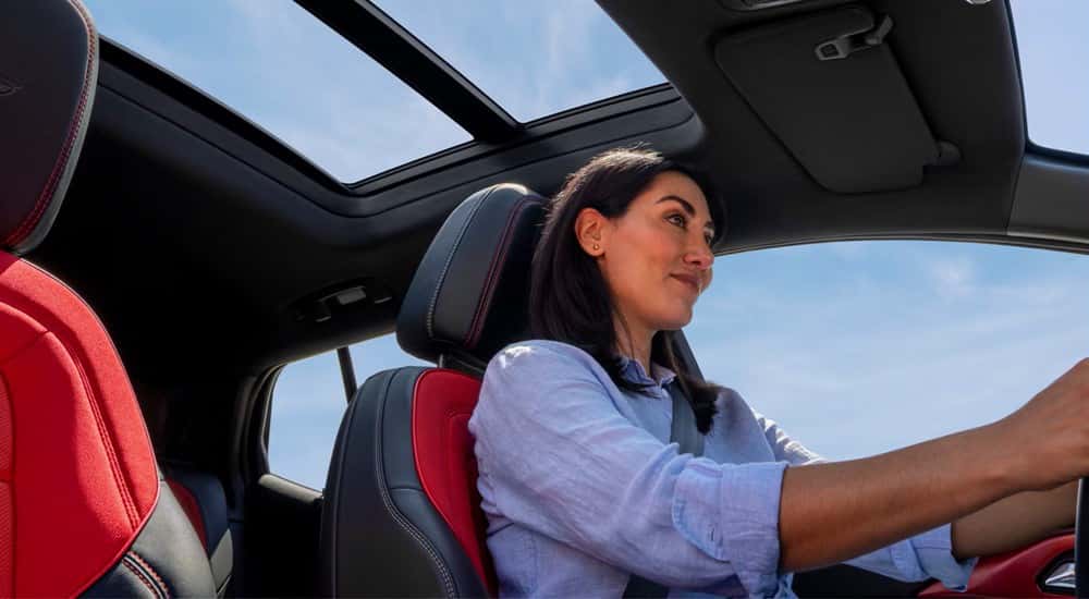 Woman driving in a 2025 Chevy Equinox EV for sale in Cincinnati