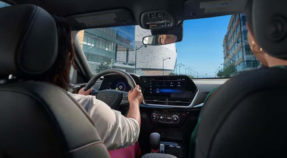 Two people driving in a 2025 Chevy Trax