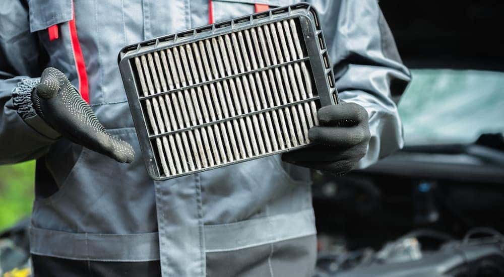 Mechanic holding an air filter