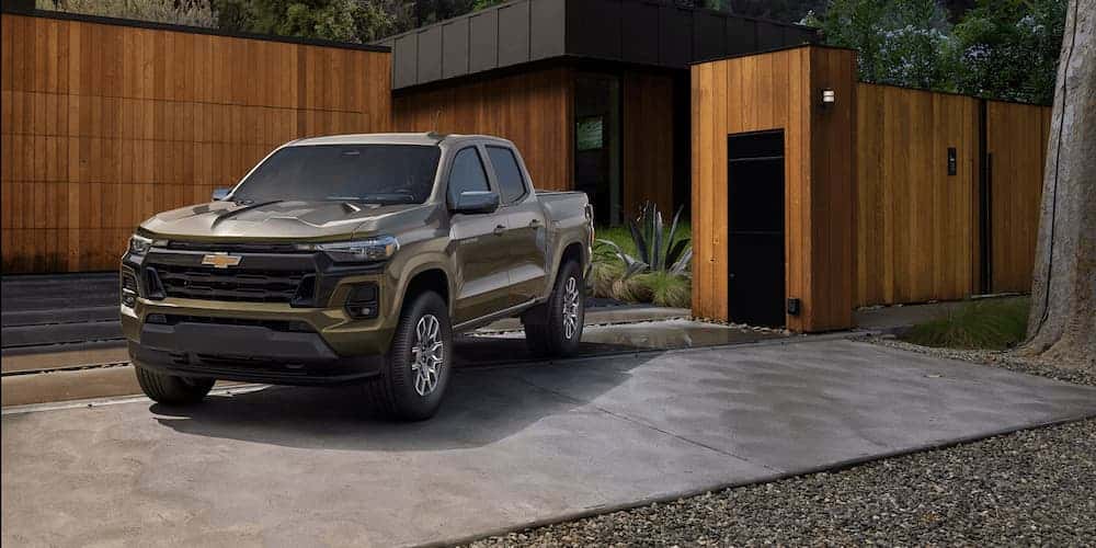 Green 2025 Chevy Colorado from the front vs the 2025 Jeep Gladiator.