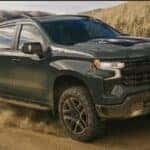 A green 2026 Chevy Silverado 1500 Z71 off-roading.