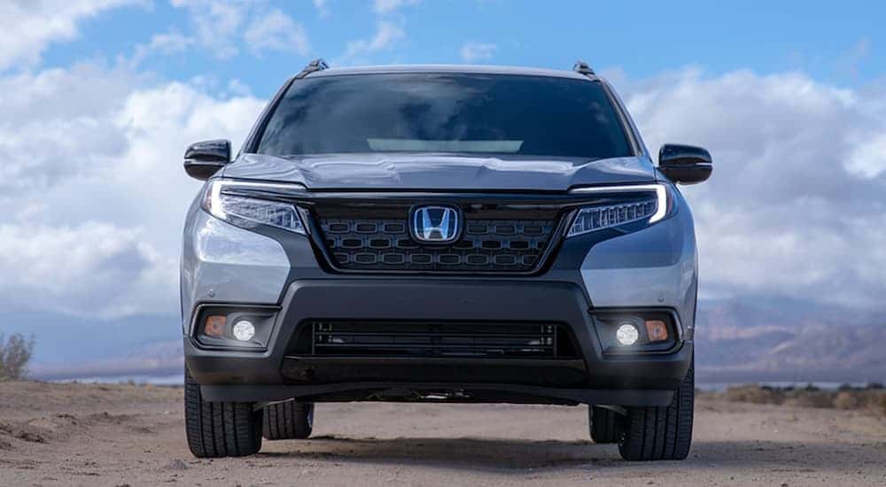 Front end of a 2025 Silver Honda Passport parked off-road.