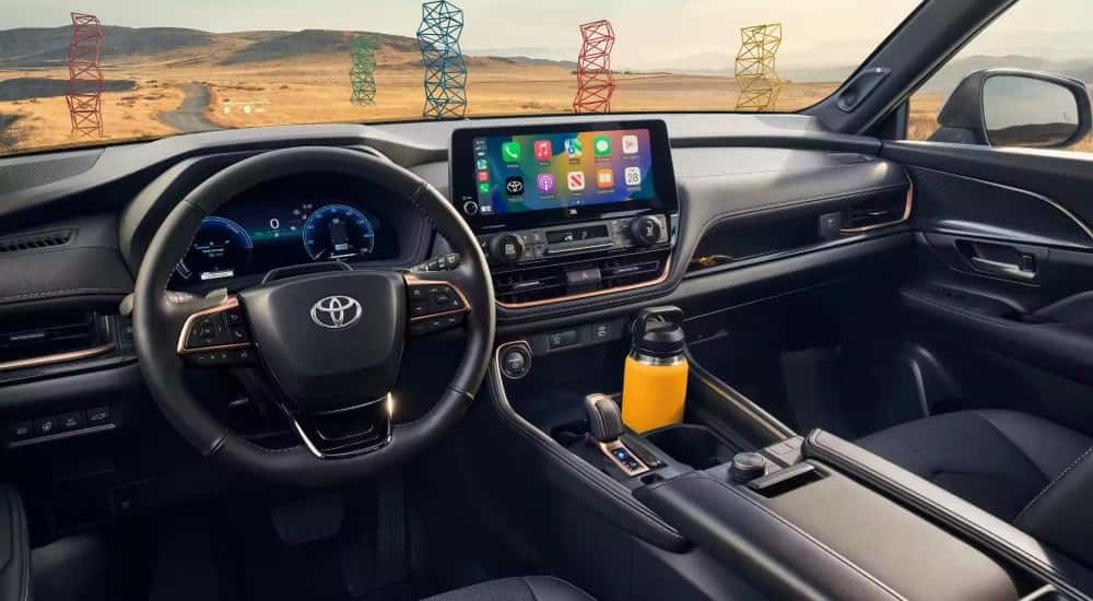Black interior of 2024 Toyota Grand Highlander parked outside.