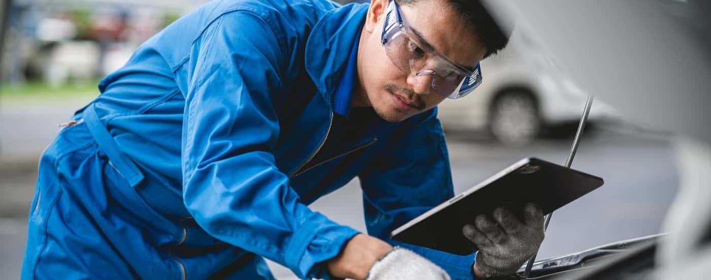A technician observing an engine.
