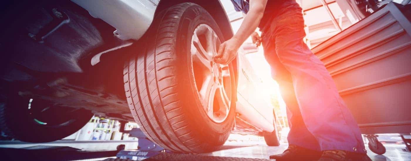 A technician putting on a lug nut.