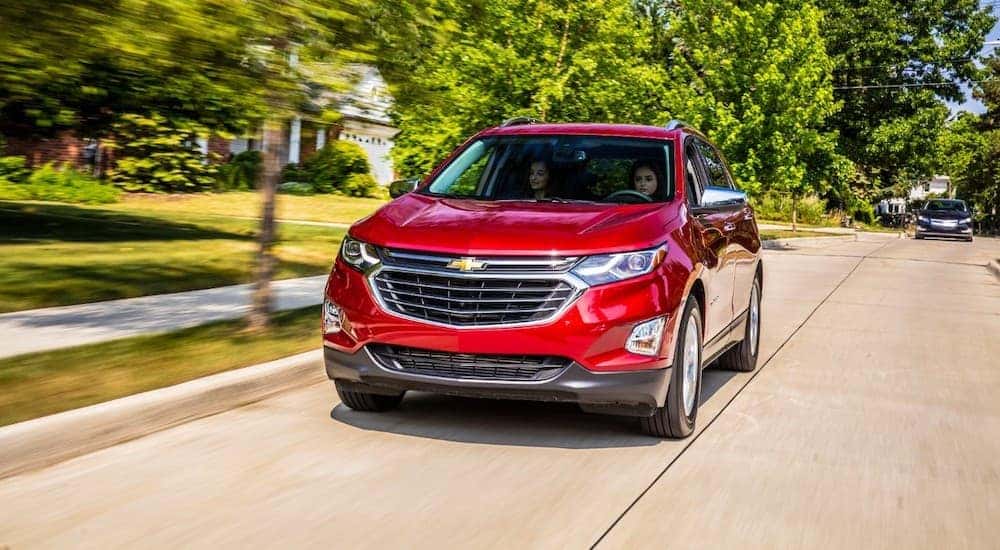Used red 2018 Chevy Equinox for sale driving down an open road.