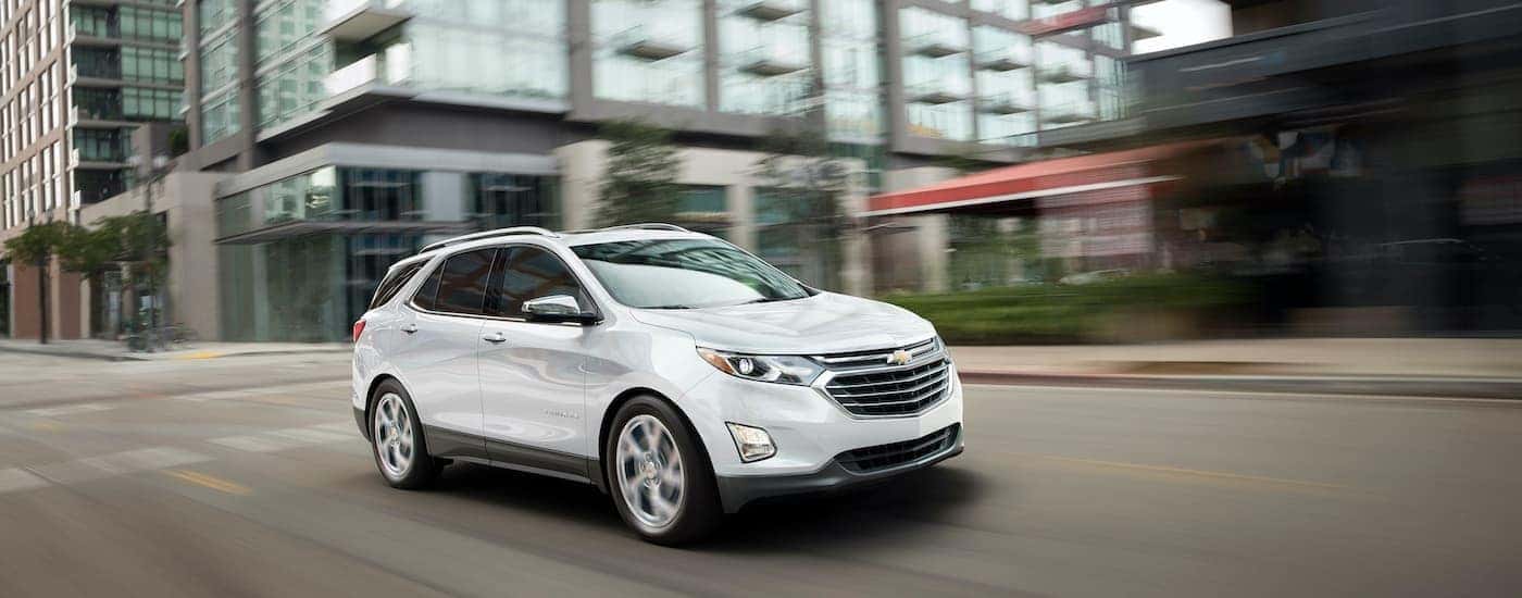 White 2019 Chevy Equinox driving to see used Chevys for sale in Cincinnati