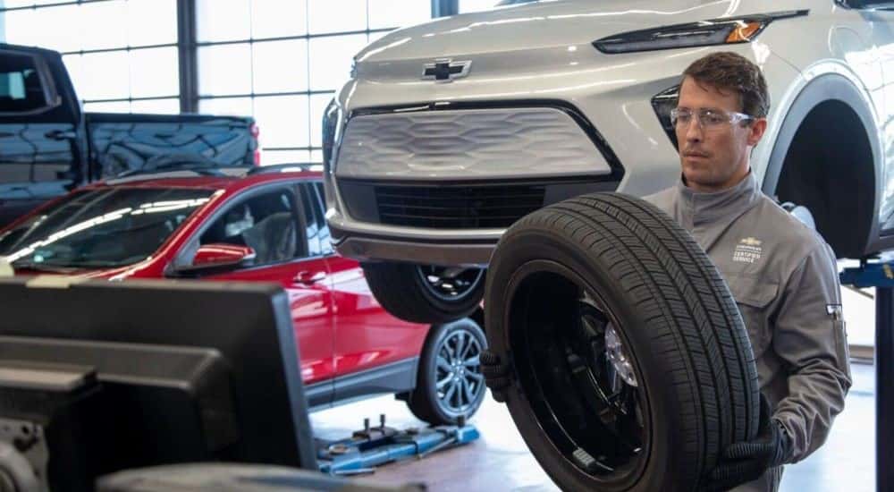 A person gets a new tire to put on to a Chevy Bolt EV