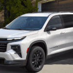 White 2026 Chevy Traverse backed in in front of a garage