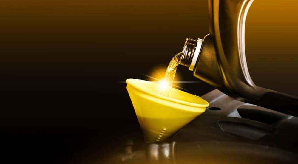 Oil being poured into a funnel.