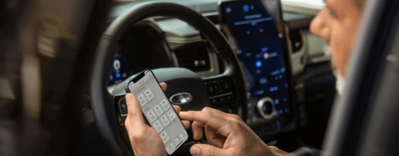 A customer uses the FordPass App on his phone