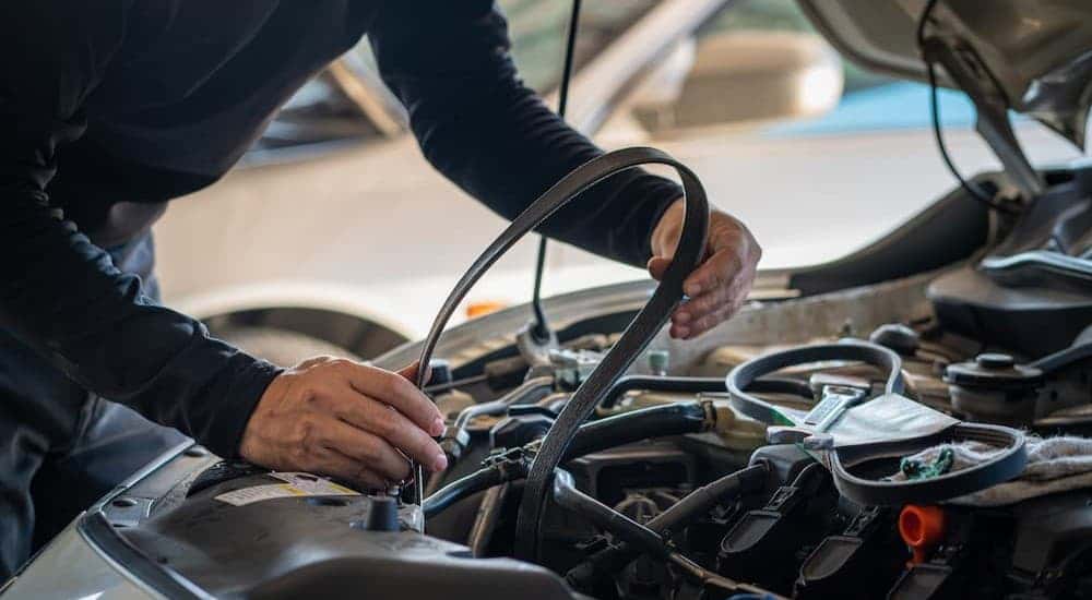 A technician changing a timing belt.