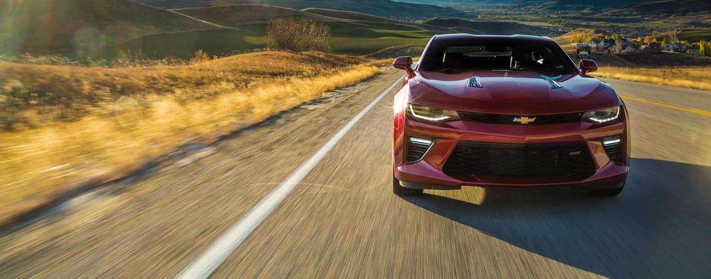 Red 2017 Chevy Camaro SS driving down a road