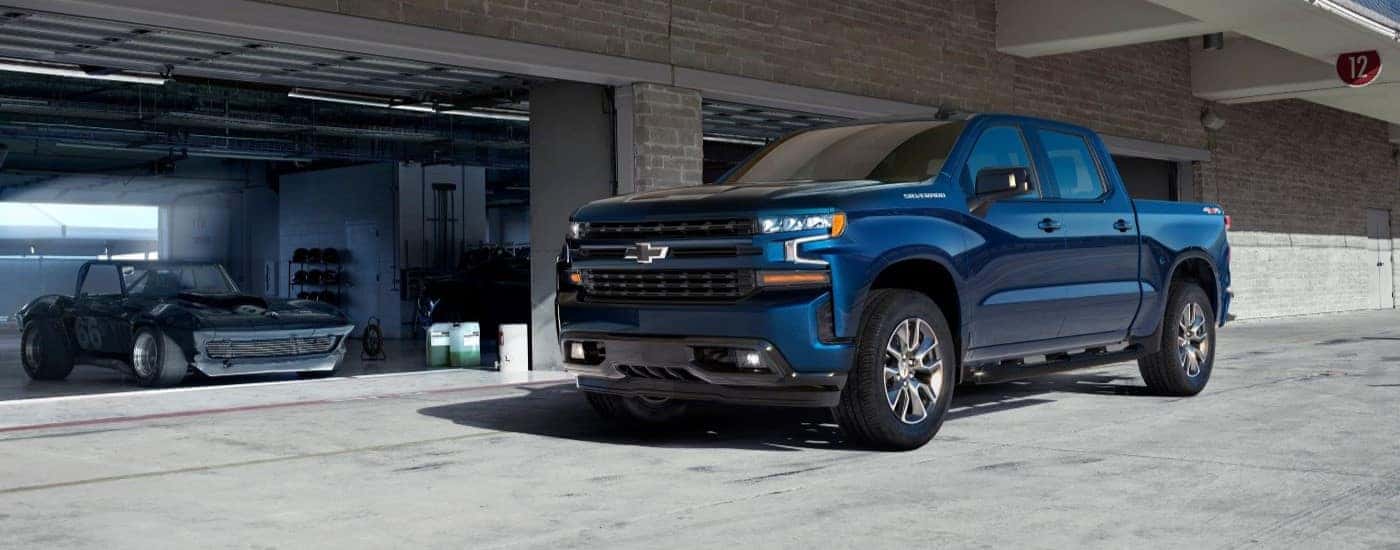 Blue 2019 Chevy Silverado 1500 parked in front of a garage