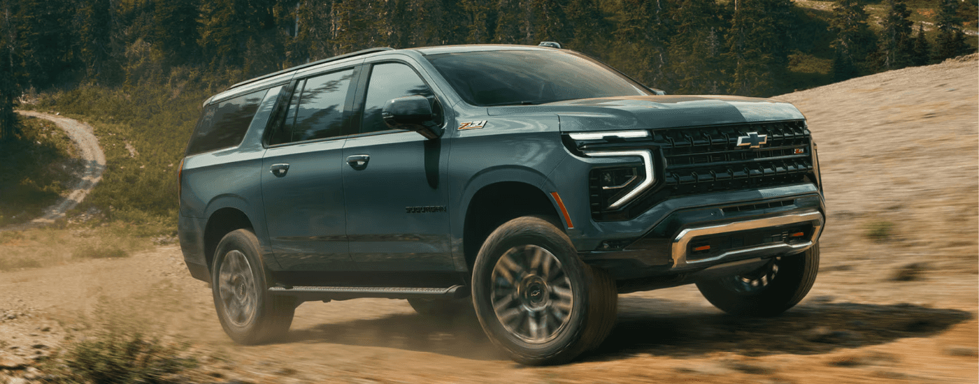 Green 2025 Chevy Suburban Z71 driving off-road