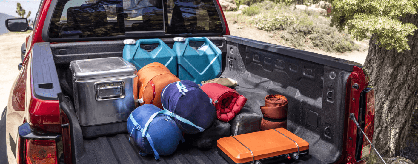 A 2026 Chevy Colorado bed filled with various items