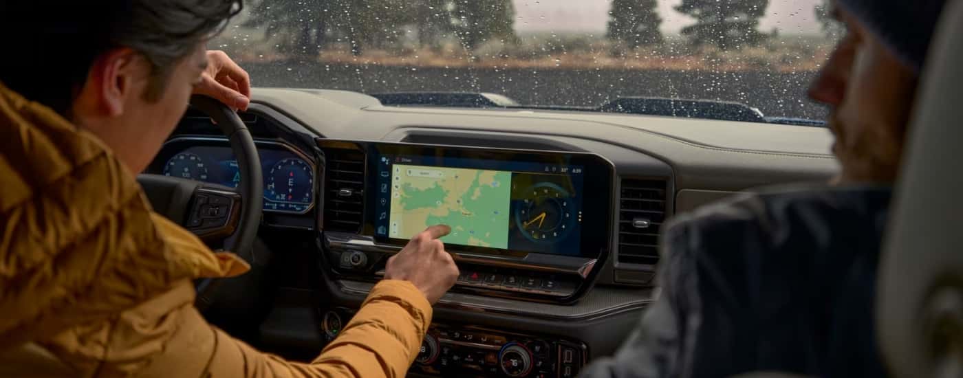 Person using the infotainment screen in a 2026 Chevy Silverado 1500