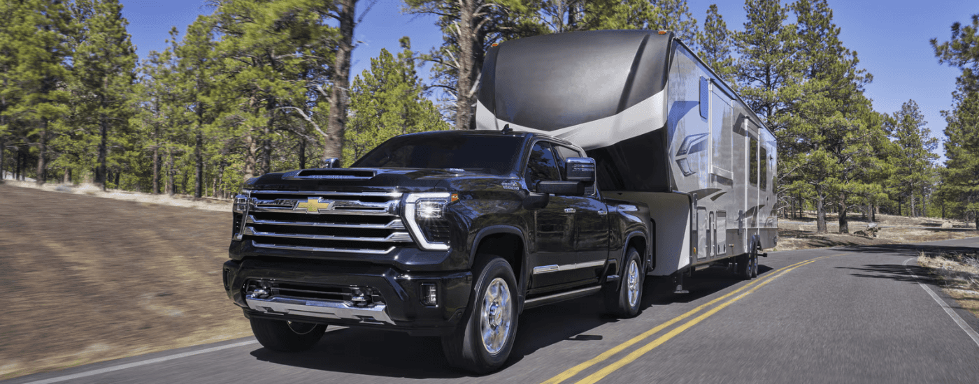 Black 2026 Chevy Silverado 2500 HD towing an RV
