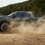 A green 2026 Chevy Silverado 3500 HD off-roading.