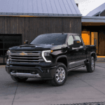 Black 2026 Chevy Silverado 2500 HD High Country parked in front of a house