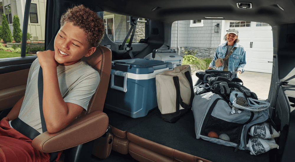 A parent loads the trunk of their 2026 Chevy Suburban