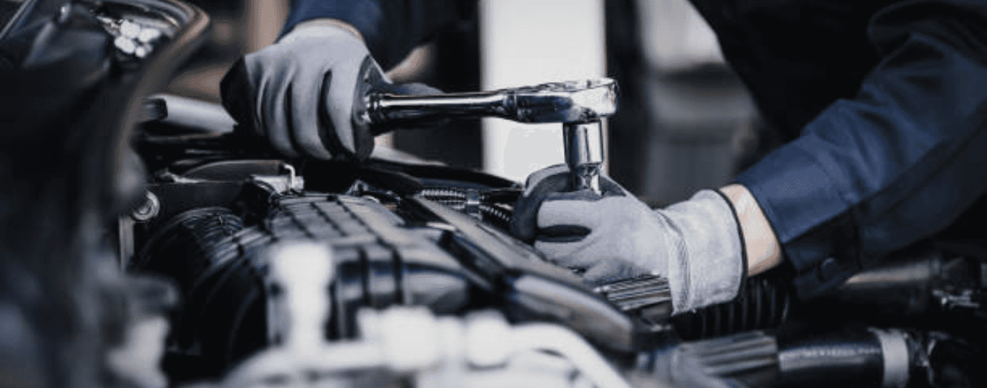 A person tighten a bolt with a ratchet