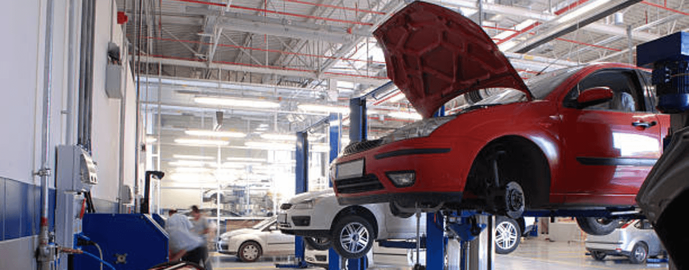 Cars on a lift in a Toyota service center near Monroe