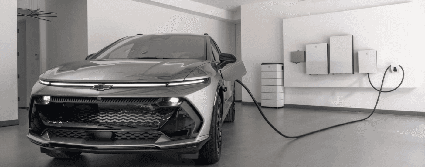 Grey 2026 Chevy Equinox EV RS charging in a garage