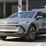 A silver 2026 Chevy Equinox EV parked on a driveway.
