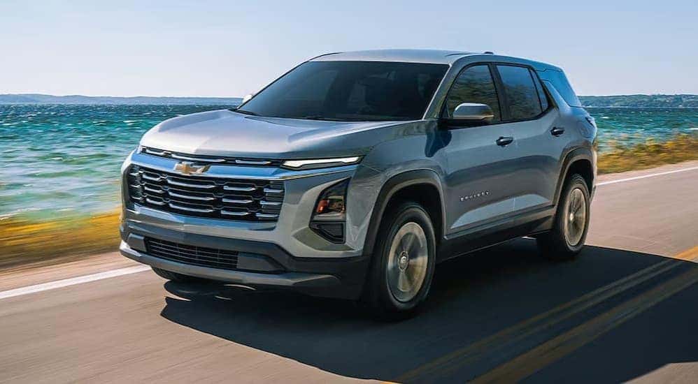 A silver 2026 Chevy Equinox driving on a highway.