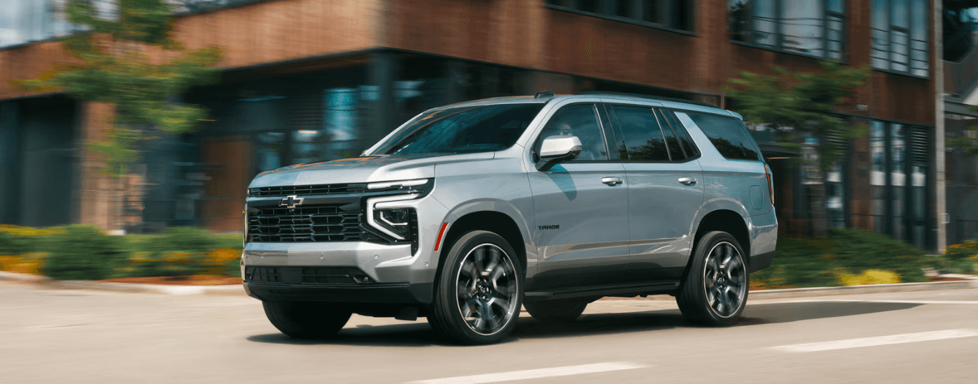 Silver 2026 Chevy Tahoe driving down the street