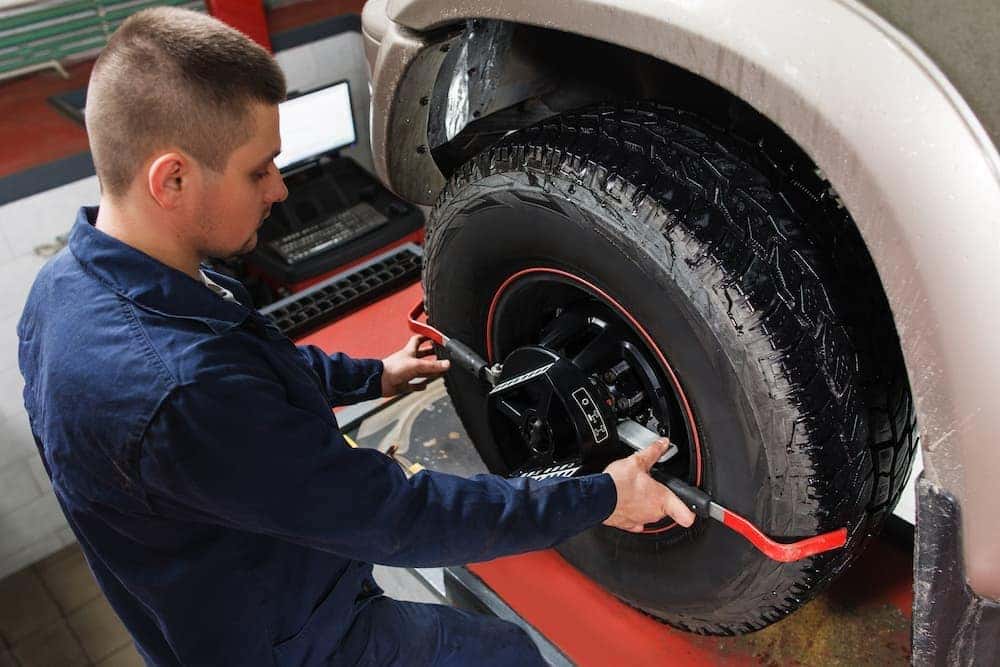 A technician performing a tire alignment.