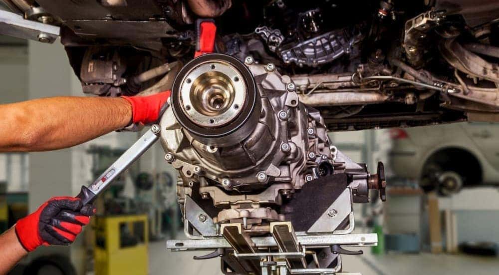 A mechanic working on a transmission