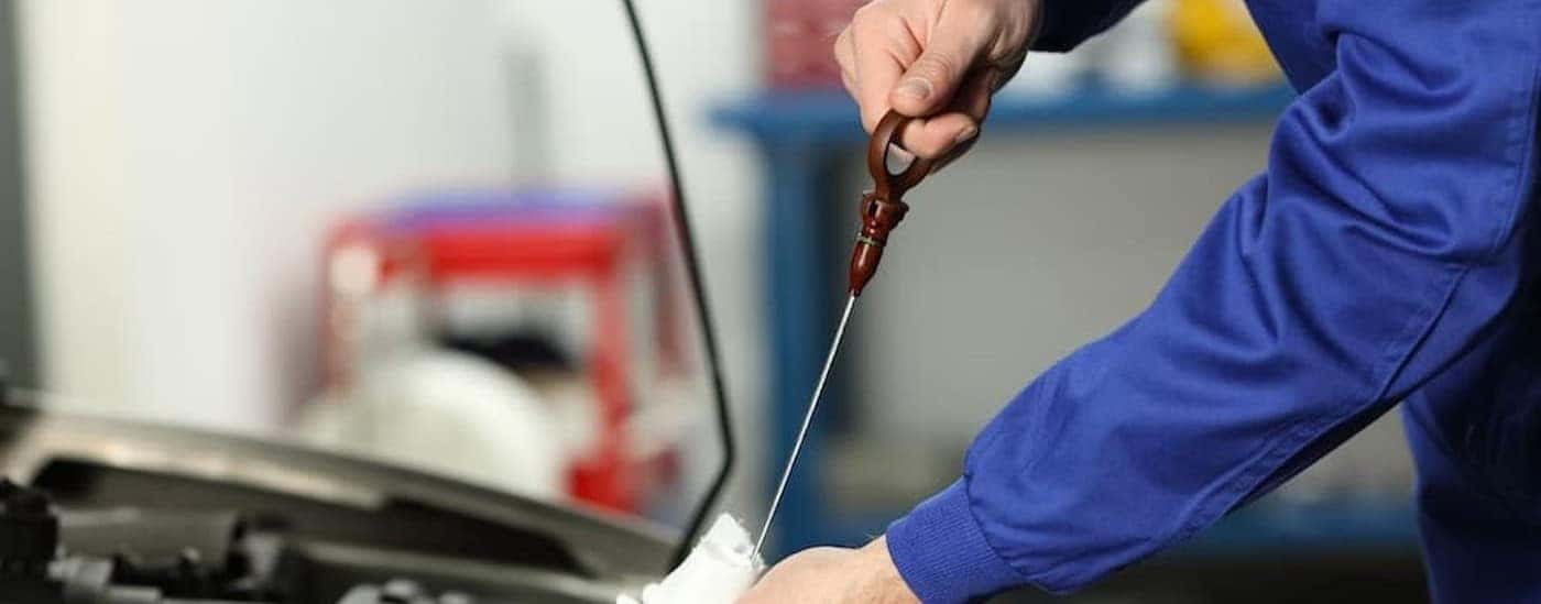 A technician checking a dipstick.