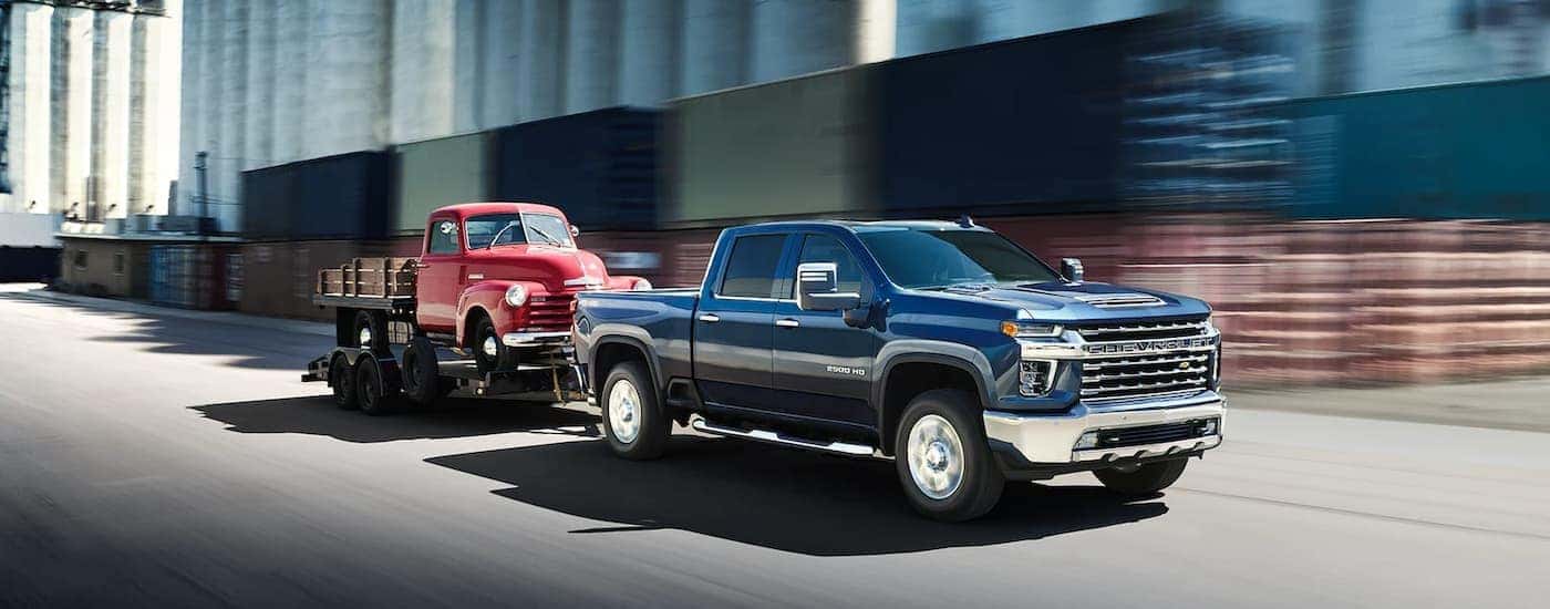 Blue 2018 Chevy Silverado 2500 HD towing a C10