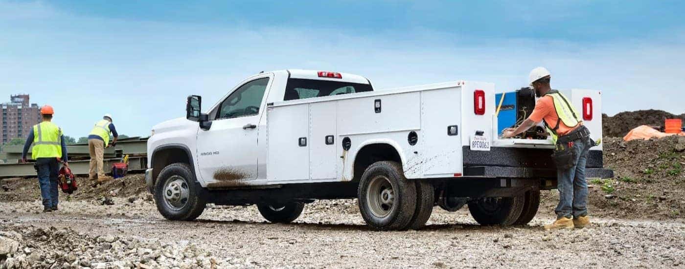 A white 2024 Chevy Silverado 3500 parked near workers.