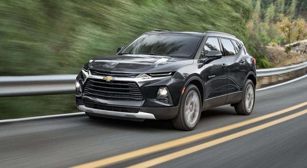 Black 2021 Chevy Blazer driving down a road.