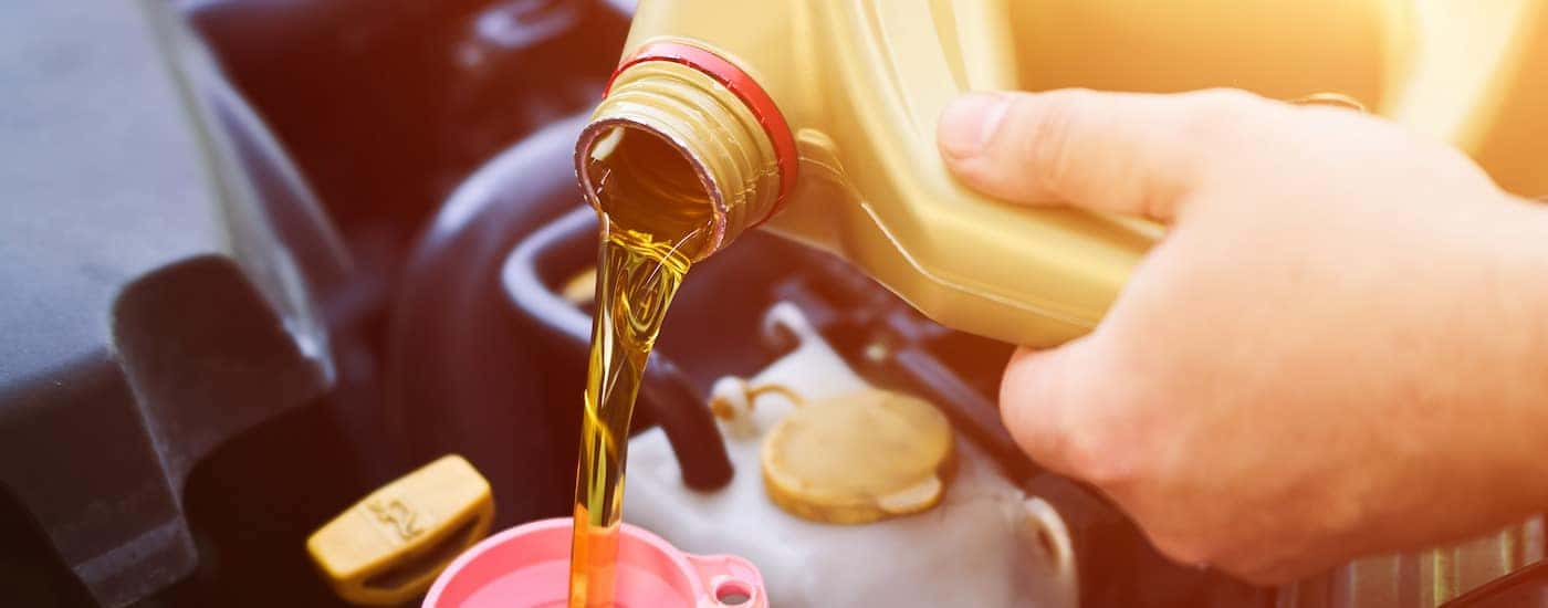 Oil can being poured into a funnel.