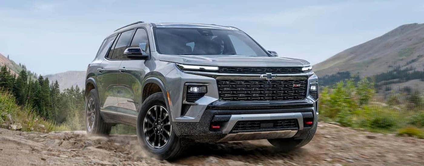 A silver 2025 Chevy Traverse off-roading for sale