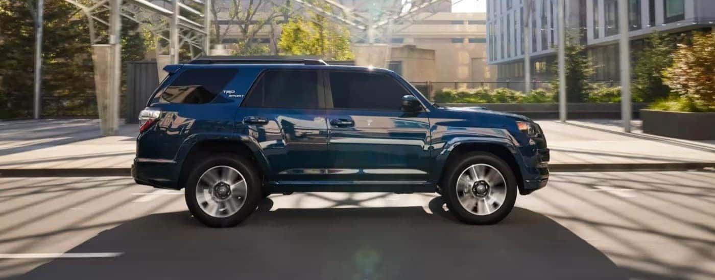 Blue 2023 Toyota 4Runner Sport driving through a city