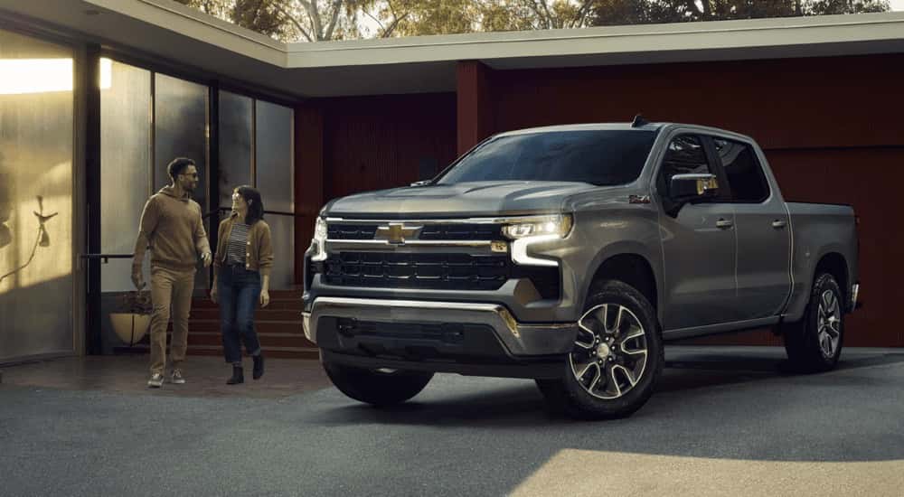 Silver 2026 Chevy Silverado 1500 backed into a driveway