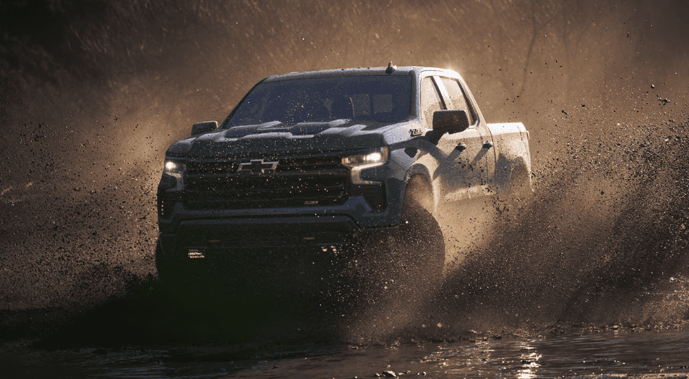 Blue 2026 Chevy Silverado 1500 Z71 drifting through mud