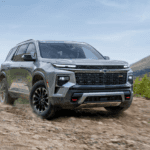 Silver 2026 Chevy Traverse driving up a trail